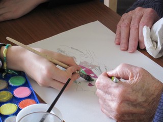 mains d'enfant et d'an dessinant ensemble